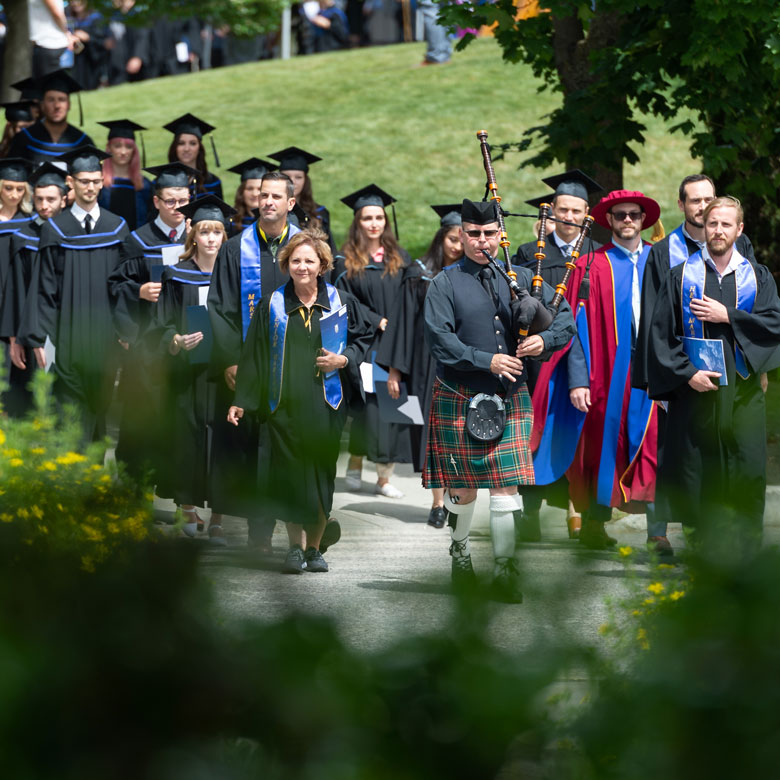 Graduation procession walking through the courtyard