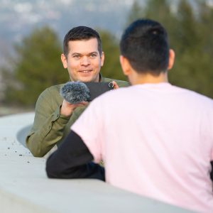 A staff member filming an interview.